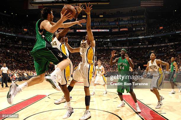 Andrea Bargnani looks for teammate Pops Mensah-Bonsu of the Toronto Raptors under the basket during a game against the Indiana Pacers on March 15,...