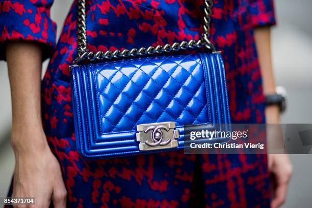 Alexandra Lapp wearing a two-piece in red and blue by Riani, a blue lacquer Chanel Boy bag, blue sunglasses by Etnia Barcelona, plexi pumps in blue...