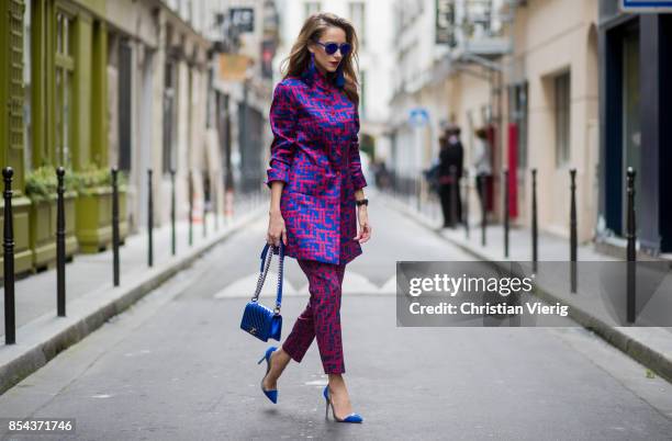 Alexandra Lapp wearing a two-piece in red and blue by Riani, a blue lacquer Chanel Boy bag, blue sunglasses by Etnia Barcelona, plexi pumps in blue...