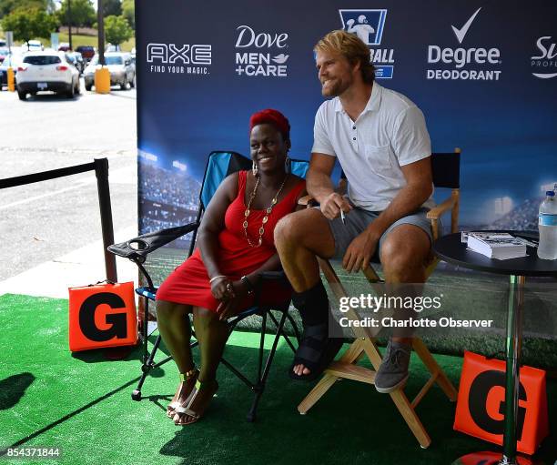Recovering from a broken right foot, Carolina Panthers tight end Greg Olsen meets with fans on Tuesday, Sept. 26 at the Family Dollar store in the...