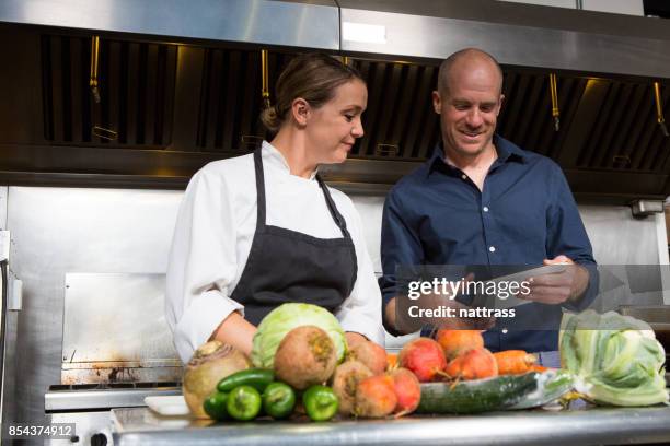 restaurant manager working together with a professional female chef - home economics class stock pictures, royalty-free photos & images