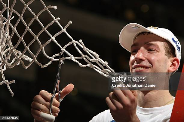 Tournament Most Outstanding Player Robbie Hummel of the Purdue Boilermakers cuts down a piece of the net after their 65-61 win against the Ohio State...