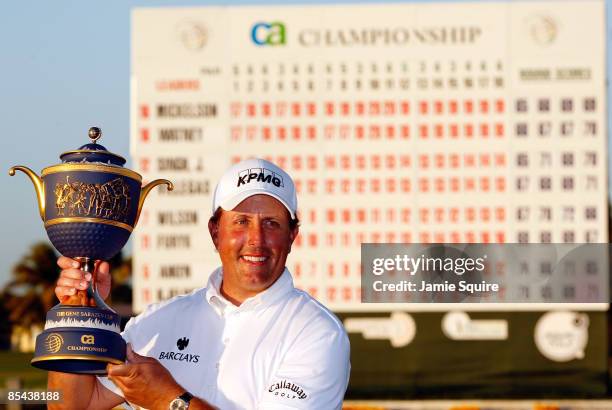 Phil Mickelson hoists the trophy after winning the World Golf Championships-CA Championship on March 15, 2009 at the Doral Golf Resort and Spa in...