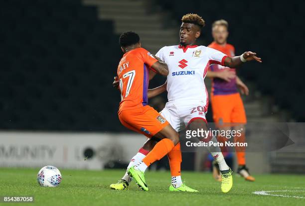 Aaron Tshibola of Milton Keynes Dons contests the ball with Raheem Hanley of Northampton Town during the Sky Bet League One match between Milton...