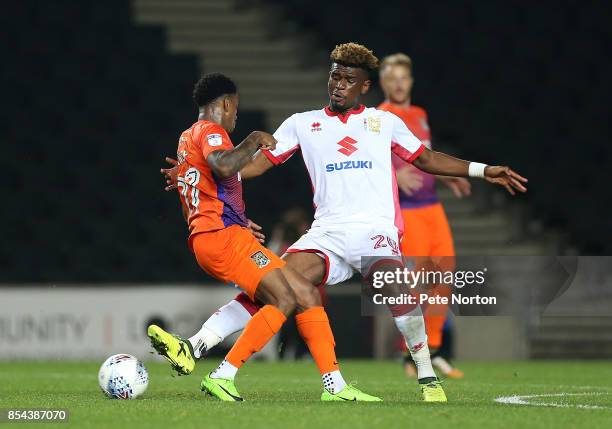 Aaron Tshibola of Milton Keynes Dons contests the ball with Raheem Hanley of Northampton Town during the Sky Bet League One match between Milton...