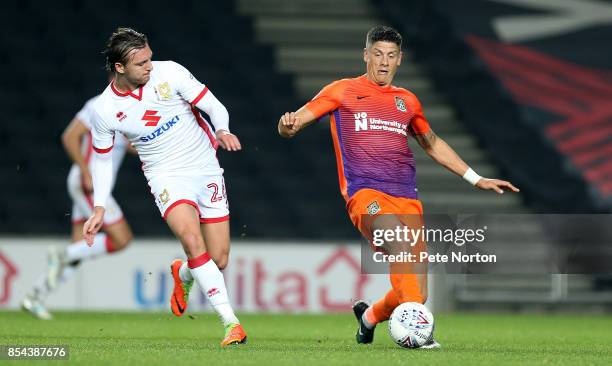 Alex Gilbey of Milton Keynes Dons contests the ball with Alex Revell of Northampton Town during the Sky Bet League One match between Milton Keynes...