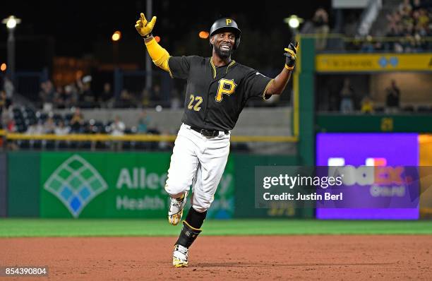 Andrew McCutchen of the Pittsburgh Pirates reacts as he rounds the bases after hitting a grand slam home run in the second inning during the game...