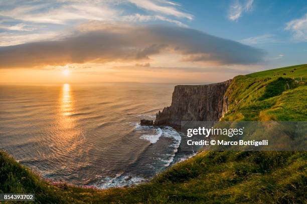 sunset over the cliffs of moher, ireland. - ireland coastline stock pictures, royalty-free photos & images