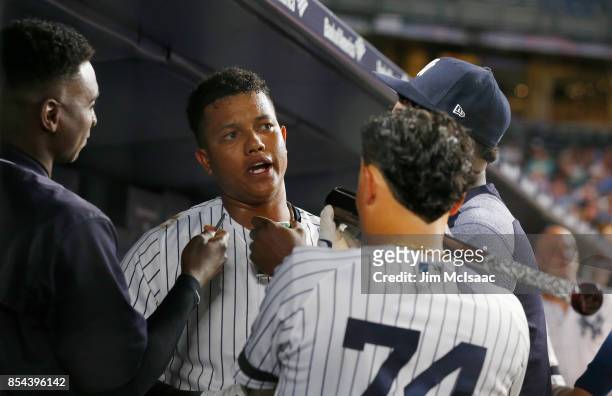 Starlin Castro of the New York Yankees celebrates his second inning home run against the Tampa Bay Rays by granting an 'interview' to teammates Didi...
