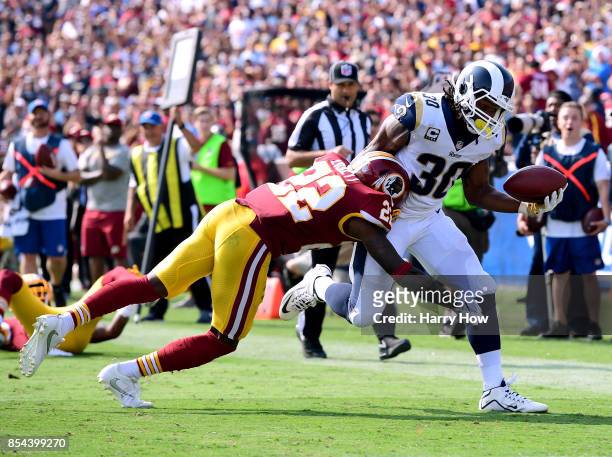 Todd Gurley of the Los Angeles Rams reaches out with the ball to score a touchdown as he is tackled by Deshazor Everett of the Washington Redskins at...