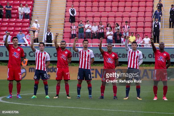 Players of Chivas and Lobos rise their fist to show support after the earthquake that struck Mexico City, Puebla and Morelos prior the 11th round...