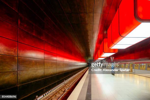 illuminated subway station in hamburg, germany - station stock-fotos und bilder