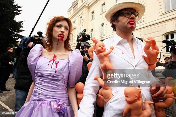 Austrian artists Iris Stromberger and Patrick Huber perform in front of the entrance of the court building on March 16, 2009 in Sankt Poelten,...