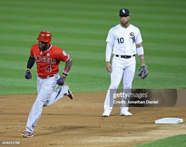 Brandon Phillips of the Los Angeles Angels runs the bases past Yoan Moncada of the Chicago White Sox after hitting a two run home run in the 2nd...