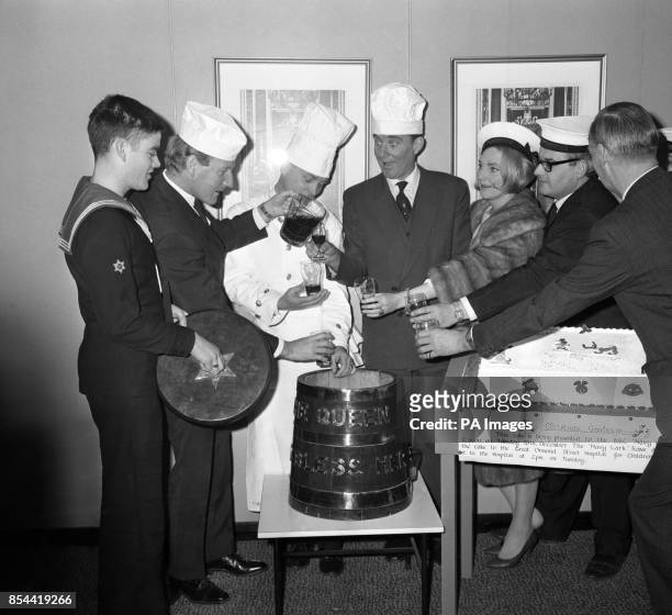 Stars of the BBC's Navy Lark visit the Royal Navy Catering Display at State House, High Holborn, London. They received a large celebration cake to...
