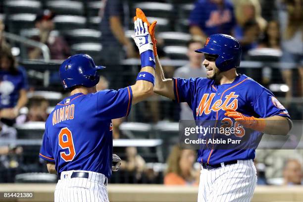 Kevin Plawecki of the New York Mets celebrates with teammate Brandon Nimmo after hitting a two-run home run in the seventh inning against the Atlanta...