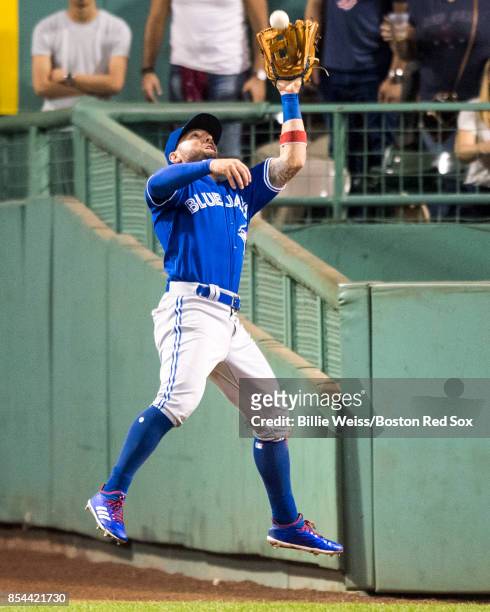 Kevin Pillar of the Toronto Blue Jays leaps as he catches a line drive during the seventh inning of a game against the Boston Red Sox on September...