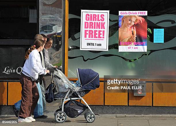 Posters advertising alcoholic drinks promotions are pictured in the window of a nightclub in Birkenhead, near Liverpool, in north-west England, on...