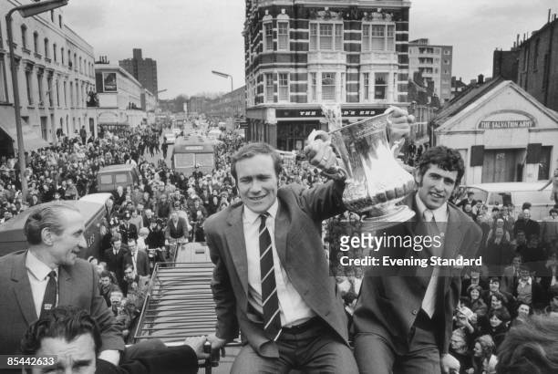 Chelsea footballers Ron Harris and Peter Bonetti lift the FA Cup during the team's open-top bus parade in front of their supporters, after Chelsea's...