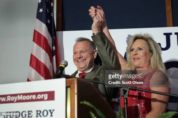 Republican candidate for the U.S. Senate in Alabama, Roy Moore and his wife Kayla greet supporters at an election-night rally on September 26, 2017...