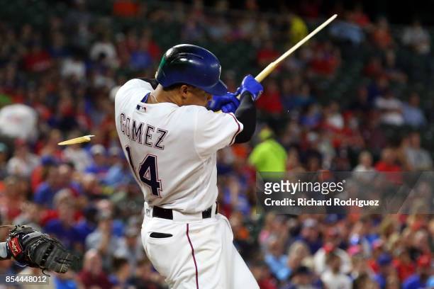 Carlos Gomez of the Texas Rangers splinters his bat on a ground out in the first inning of a baseball game against the Houston Astros at Globe Life...