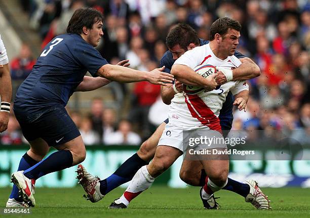 Lee Mears of England is tackled by Sylvain Marconnet and Lionel Faure of France during the RBS 6 Nations Championship match between England and...