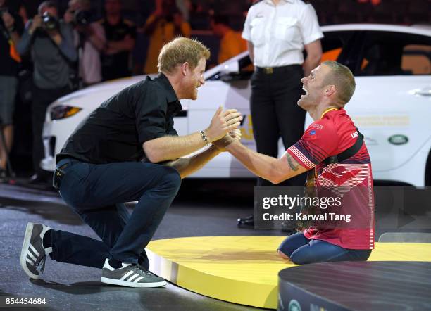 Prince Harry presents Mark Ormrod with his medal during the Rowing at the Invictus Games Toronto 2017 at the Mattamy Athletic Centre on September 26,...