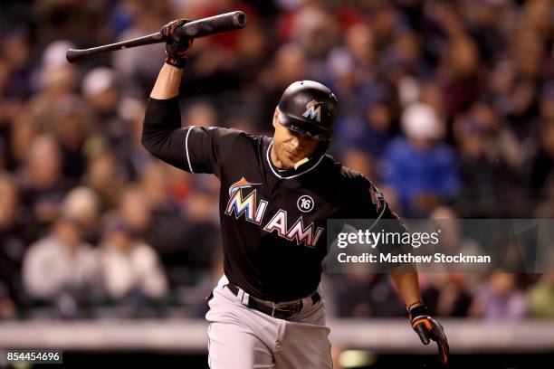 Giancarlo Stanton of the Miami Marlins reacts to flying out in the sixth inning against the Colorado Rockies at Coors Field on September 26, 2017 in...