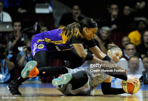 Lindsay Whalen of the Minnesota Lynx holds onto the ball after falling to the court as Odyssey Sims of the Los Angeles Sparks reaches in during the...