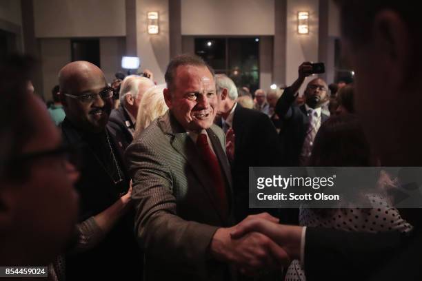 Republican candidate for the U.S. Senate in Alabama, Roy Moore greets supporters at an election-night rally after declaring victory on September 26,...