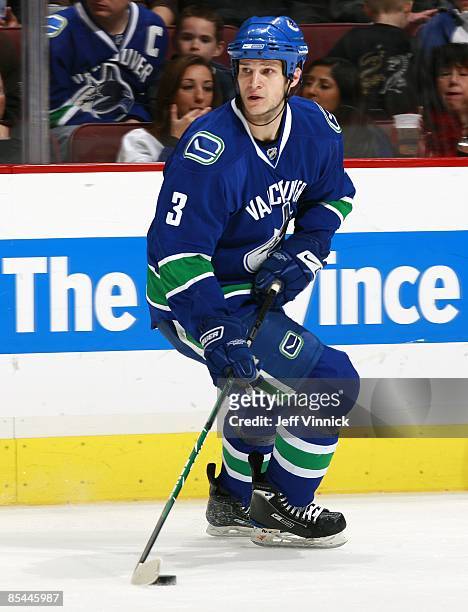 Kevin Bieksa of the Vancouver Canucks skates up ice with the puck during their game against the Minnesota Wild at General Motors Place on March 3,...