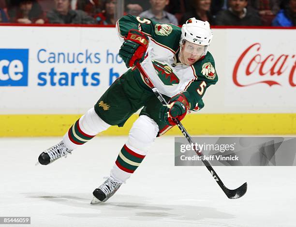 Kim Johnsson of the Minnesota Wild passes the puck up ice during their game against the Vancouver Canucks at General Motors Place on March 3, 2009 in...