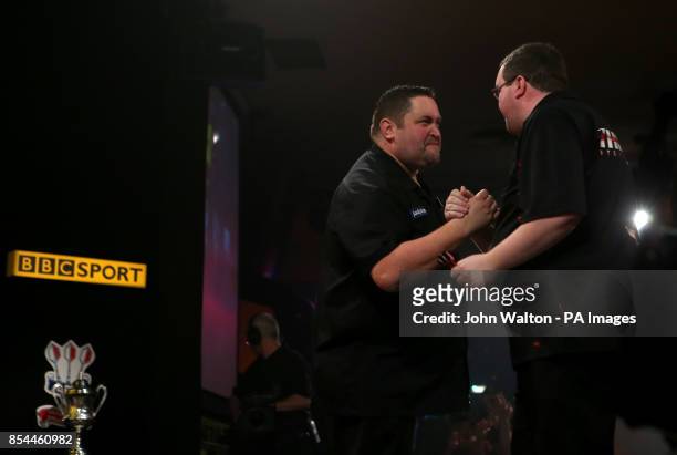 Alan Norris shakes hands with Stephen Bunting before the start of the BDO World Championships Final at the Lakeside Complex, Surrey.