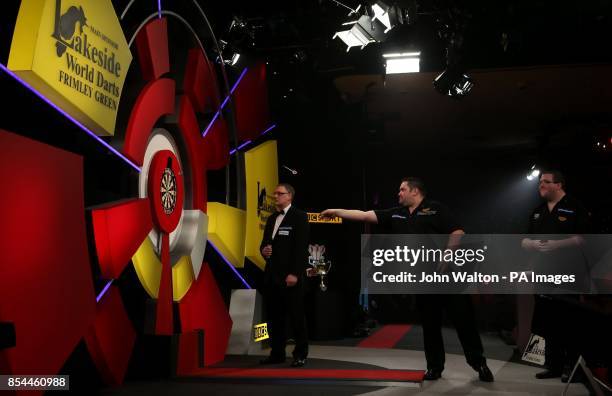 Alan Norris throws watched by Stephen Bunting during the BDO World Championships Final at the Lakeside Complex, Surrey.