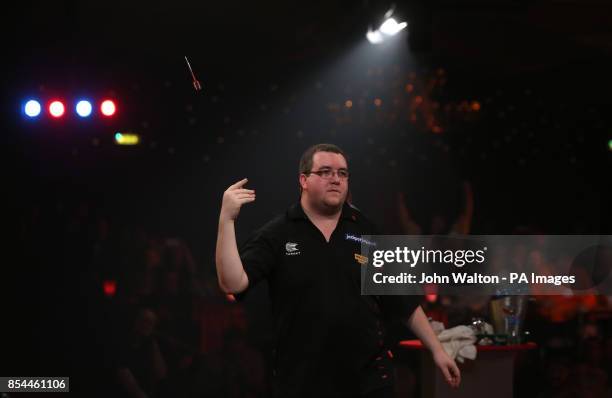 Stephen Bunting throws his spare dart up in the air as he celebrates winning the match during the BDO World Championships Final at the Lakeside...