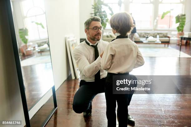 he gets his style from dad - adult in mirror stock pictures, royalty-free photos & images