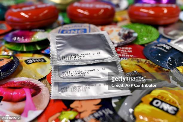 In this picture taken September 20 packs of "nasi lemak" flavoured condoms are seen amidst others at the Malaysian condom-maker Karex Industries...