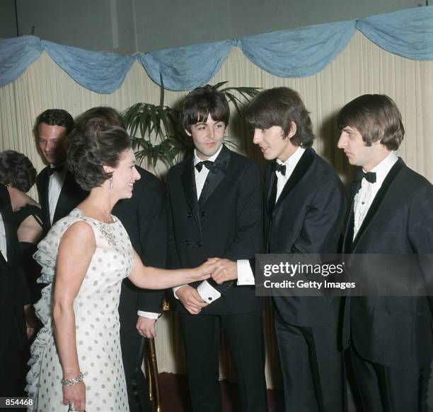 Princess Margaret shakes hands with George Harrison, Paul McCartney and Ringo Starr of the British pop group the Beatles in 1965 in London, England....