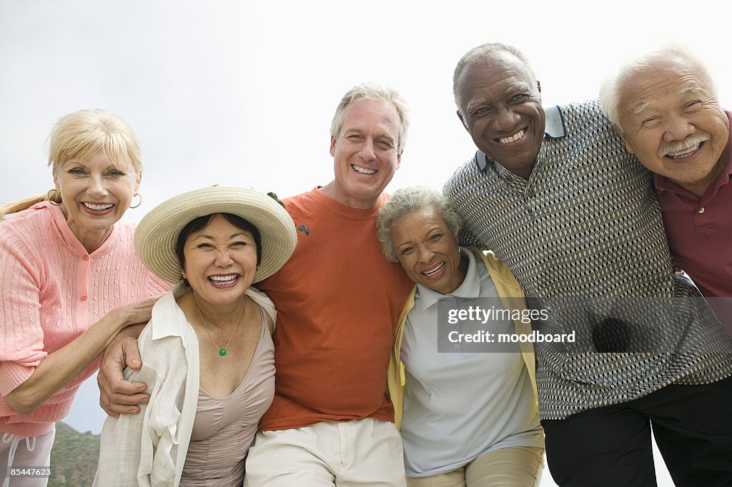Group of friends embracing and smiling at camera