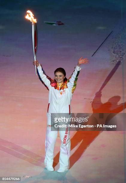 Russian gymnast Alina Kabaeva holds the torch during the Opening Ceremony for the 2014 Sochi Olympic Games at the Fisht Olympic Stadium, near Sochi,...