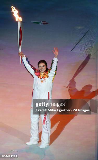 Russian gymnast Alina Kabaeva holds the torch during the Opening Ceremony for the 2014 Sochi Olympic Games at the Fisht Olympic Stadium, near Sochi,...