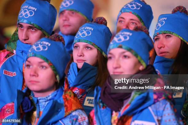 Volunteers gather to watch the opening ceremony for the 2014 Sochi Olympic Games on giant tv screens in Rosa Khutor, Russia.