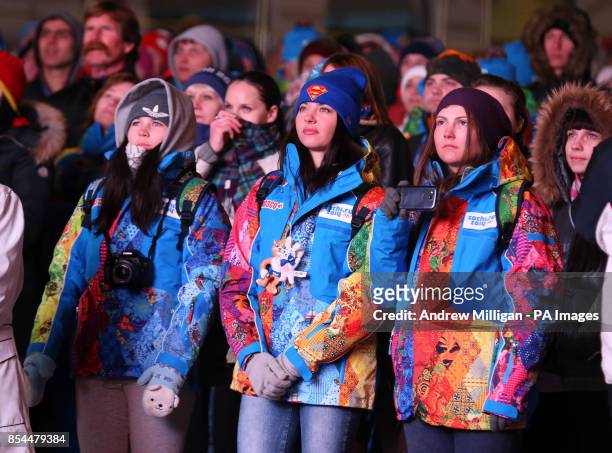 Volunteers gather to watch the opening ceremony for the 2014 Sochi Olympic Games on giant tv screens in Rosa Khutor, Russia.