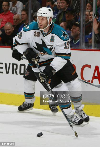 Joe Thornton of the San Jose Sharks skates up ice with the puckduring their game against the Vancouver Canucks at General Motors Place on March 7,...