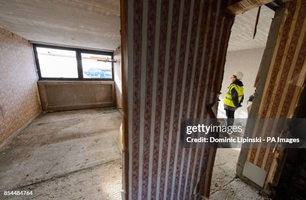 Construction worker inside an empty flat on the Heygate Estate, in Elephant and Castle, in south London, which is in the process of being demolished.