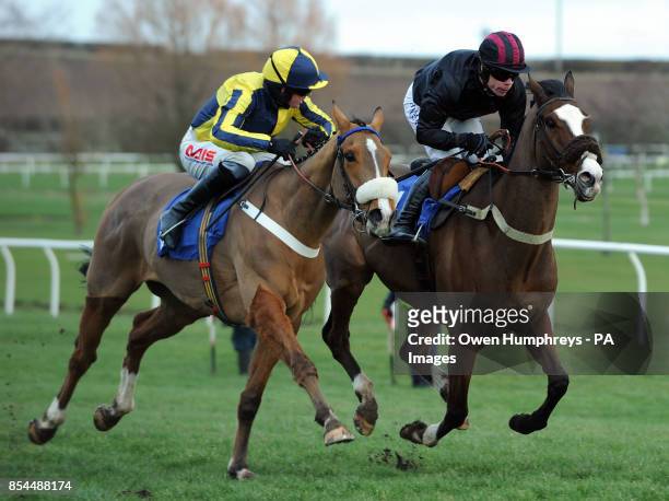 Master Red ridden by Jason Maguire and Rainbow Peak ridden by Denis O'Regan in action in the David Merry Farrier Novices' Hurdle during the...