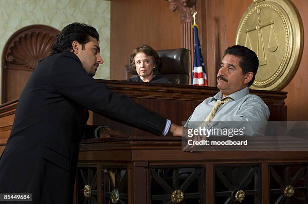 judge watching prosecution in court - legal defense stock pictures, royalty-free photos & images