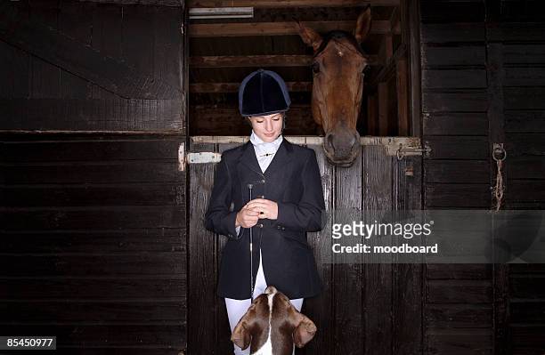 horse rider with dog and horse at stable - jockey foto e immagini stock