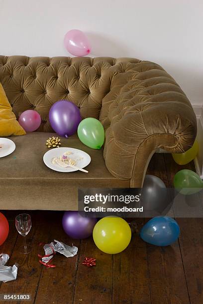 balloons scattered around sofa - after party mess stock pictures, royalty-free photos & images