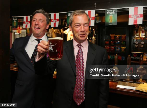 Ukip party leader Nigel Farage enjoys a pint in the Hoy and Helmet Pub in South Benfleet, Essex, as his party make gains across the country following...